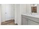 Clean bathroom with gray vanity, white walls, and wood-look tile floor at 11250 Torch Cactus Dr, Las Vegas, NV 89138