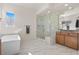 Spa-like bathroom with soaking tub, large shower, and modern vanity at 11250 Torch Cactus Dr, Las Vegas, NV 89138