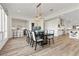 Open concept dining room with hardwood floors, kitchen views, and modern chandelier at 11250 Torch Cactus Dr, Las Vegas, NV 89138