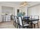 Elegant dining room with a dark wood table and access to a wet bar at 11250 Torch Cactus Dr, Las Vegas, NV 89138