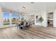 Bright dining room features a large table, chandelier, and hardwood floors at 11250 Torch Cactus Dr, Las Vegas, NV 89138