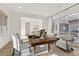 Sunlit home office features hardwood floors and a large wooden desk at 11250 Torch Cactus Dr, Las Vegas, NV 89138