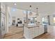 Open concept kitchen with large island and farmhouse sink, stainless steel appliances, and hardwood floors at 11250 Torch Cactus Dr, Las Vegas, NV 89138