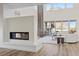 Open living room with modern fireplace, hardwood floors, and high ceilings at 11250 Torch Cactus Dr, Las Vegas, NV 89138