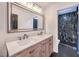 Double vanity bathroom with modern fixtures and a large mirror at 1516 Via Salaria Ct, Henderson, NV 89052