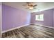 Spacious bedroom with light purple walls and wood-look flooring at 1516 Via Salaria Ct, Henderson, NV 89052