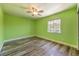 Bright bedroom with light green walls and wood-look flooring at 1516 Via Salaria Ct, Henderson, NV 89052