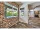 Bright dining area with brick accent wall and pool view at 1516 Via Salaria Ct, Henderson, NV 89052