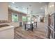 Modern kitchen with brick accent wall, island, and stainless steel appliances at 1516 Via Salaria Ct, Henderson, NV 89052