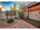 Landscaped backyard with decorative rock and wooden arbor at 1555 Bent Arrow Dr, North Las Vegas, NV 89031