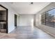 Bright bedroom with large window, mirrored closet doors and grey laminate floor at 1865 Apricot Ct, Henderson, NV 89014