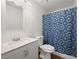 Bathroom featuring an updated vanity, toilet, and shower with a blue patterned curtain at 2214 Pebble Creek Ln, Laughlin, NV 89029