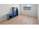 Bedroom featuring wood-look floors, neutral wall color, and blue shelving at 2214 Pebble Creek Ln, Laughlin, NV 89029