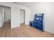 Bedroom featuring wood-look floors, neutral wall color, blue shelving, and a closet at 2214 Pebble Creek Ln, Laughlin, NV 89029