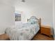 Bedroom featuring wood-look floors, a wrought iron bed frame, and a window at 2214 Pebble Creek Ln, Laughlin, NV 89029