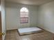 Bright bedroom with arched window and tile floors at 2961 Juniper Hills Blvd # 102, Las Vegas, NV 89142