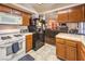 Kitchen with wood cabinets, white appliances, and a breakfast bar at 4705 Rockvale Dr, Las Vegas, NV 89103