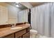 Bathroom with granite countertop, shower/tub combo, and wood vanity at 5957 Pillar Rock Ave, Las Vegas, NV 89139