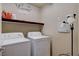 Bright laundry room with washer, dryer, and shelving at 5957 Pillar Rock Ave, Las Vegas, NV 89139