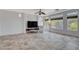 Bright living room with tile floors, large windows, and a modern TV stand at 5957 Pillar Rock Ave, Las Vegas, NV 89139