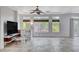 Spacious living room featuring tile floors, large windows, and a ceiling fan at 5957 Pillar Rock Ave, Las Vegas, NV 89139