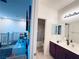 View of a bathroom and hallway featuring a shower, vanity with double sinks, and white cabinets at 647 Wounded Star Ave, Las Vegas, NV 89178