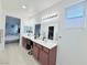 Bathroom featuring double sinks, large mirror, vanity space, and easy access to a bedroom at 647 Wounded Star Ave, Las Vegas, NV 89178