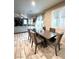 Dining area with wooden table, comfortable seating, and bright natural light with views into the living room at 647 Wounded Star Ave, Las Vegas, NV 89178