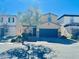 Charming two-story home featuring a two-car garage, desert landscaping, and a welcoming facade at 647 Wounded Star Ave, Las Vegas, NV 89178