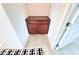 Hallway showing built-in shelving and storage area with tiled flooring, leading to door at 647 Wounded Star Ave, Las Vegas, NV 89178