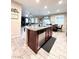 Open floor plan showcasing kitchen island with granite countertops and stainless steel dishwasher, with dining in view at 647 Wounded Star Ave, Las Vegas, NV 89178