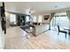 Open-concept living room with a fireplace, tile flooring, and sliding glass doors to the backyard at 647 Wounded Star Ave, Las Vegas, NV 89178