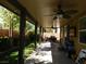 Covered patio with ceiling fan, outdoor seating, and a view of the backyard at 647 Wounded Star Ave, Las Vegas, NV 89178