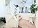 A carpeted staircase with white railings leads to a loft area, decorated with plants and a ceiling fan at 647 Wounded Star Ave, Las Vegas, NV 89178