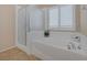 Bathroom with shower and tub, updated fixtures, and window at 734 Holland Heights Ave, Las Vegas, NV 89123