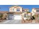 Two-story house with a white garage door and landscaping at 734 Holland Heights Ave, Las Vegas, NV 89123