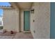 Inviting front entrance with a teal door and exterior light fixture at 734 Holland Heights Ave, Las Vegas, NV 89123