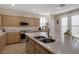 Kitchen with island, stainless steel appliances, and light wood cabinets at 734 Holland Heights Ave, Las Vegas, NV 89123