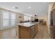 Open concept kitchen with island, stainless steel appliances, and light wood cabinets at 734 Holland Heights Ave, Las Vegas, NV 89123