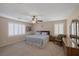 Bright main bedroom with large windows and ceiling fan at 734 Holland Heights Ave, Las Vegas, NV 89123