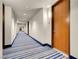 Building hallway with carpeted floor and wood doors at 8255 One Las Vegas Blvd # 504, Las Vegas, NV 89123