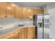 Corner kitchen with light wood cabinets and granite countertops at 8255 One Las Vegas Blvd # 504, Las Vegas, NV 89123