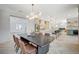 Modern dining area with sleek table and chairs, open to kitchen at 10981 Laureldale Ct, Las Vegas, NV 89141