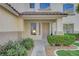 House entrance with a covered porch, landscaping, and a walkway at 10981 Laureldale Ct, Las Vegas, NV 89141