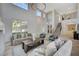 Open living room with two-story ceilings, a fireplace, and herringbone floors at 10981 Laureldale Ct, Las Vegas, NV 89141