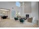 Two-story living room with hardwood floors, a fireplace, and high ceilings at 10981 Laureldale Ct, Las Vegas, NV 89141