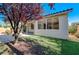 Home exterior with a well-maintained artificial lawn and a stone patio area at 11119 Cantoria Ct, Las Vegas, NV 89141