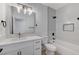 Modern bathroom with a vanity, a toilet, and a combined shower and tub with white tiling at 11119 Cantoria Ct, Las Vegas, NV 89141