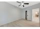 A simplistic bedroom design with neutral walls, a ceiling fan, and a closet with sliding doors at 11119 Cantoria Ct, Las Vegas, NV 89141