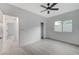 A simple bedroom design with neutral walls, a ceiling fan, a closet, and a window at 11119 Cantoria Ct, Las Vegas, NV 89141